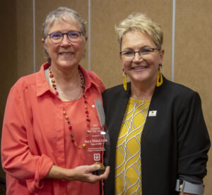 MU College of Veterinary Medicine CVM Alumna of the Year Mary Whitlock, DVM, accepts her award from CVM Dean Carolyn Henry.
