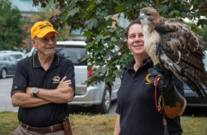 During the tailgate brunch, Lizette Somer, a volunteer with the Raptor Rehabilitation Project, visits with alumnus Gary Weddle, DVM ’78, who was involved with the project during his years at the CVM.