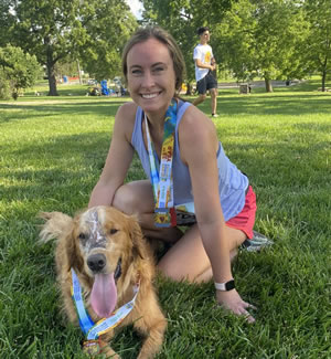 Nicole Schuh and her dog, Oliver, pose together after completing a 5K.