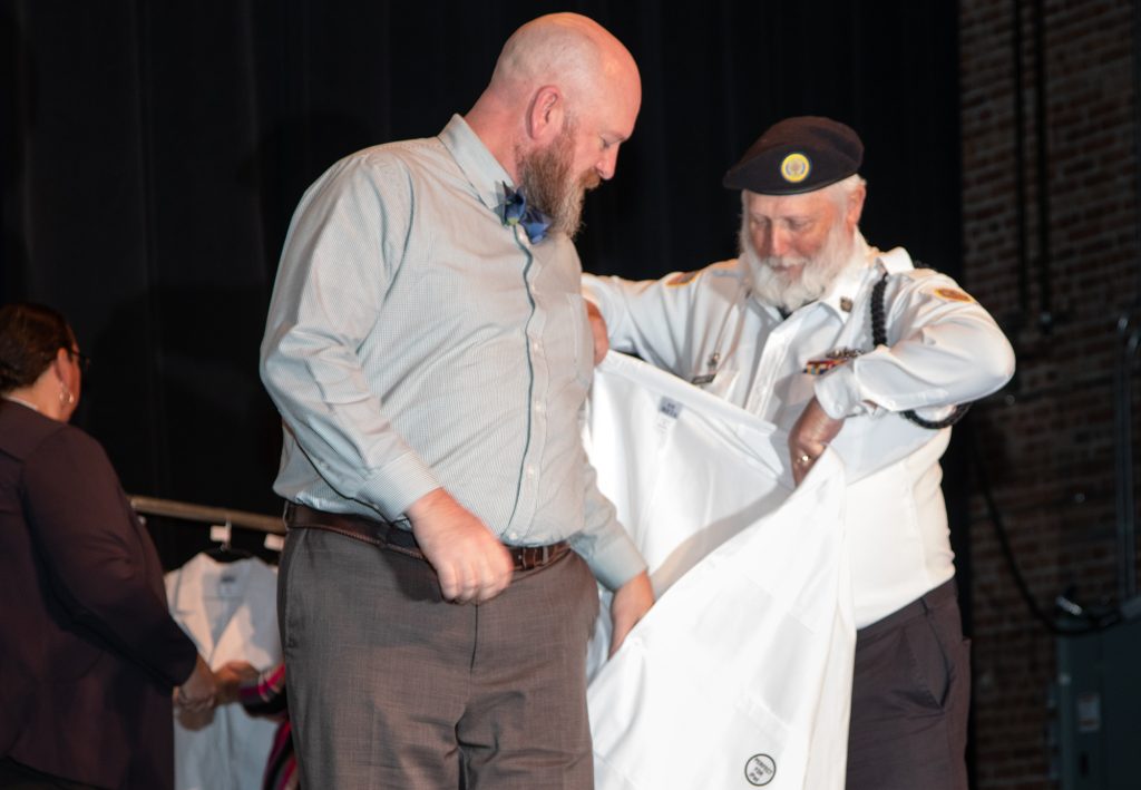 Hansen receiving his white coat last October.
