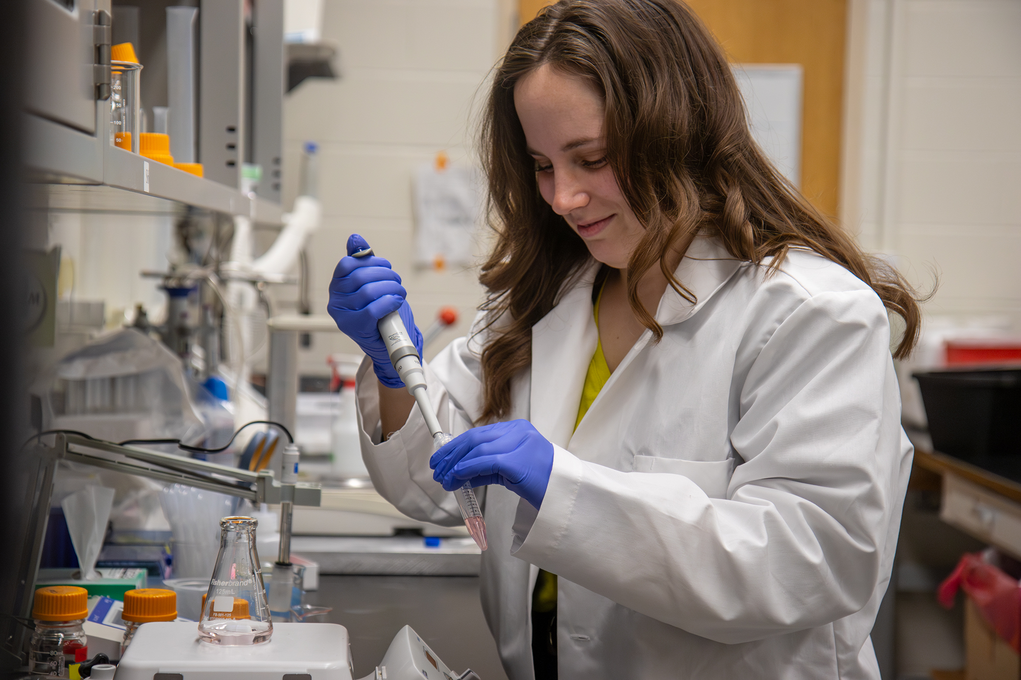 sandy saunders with a pipette in a lab