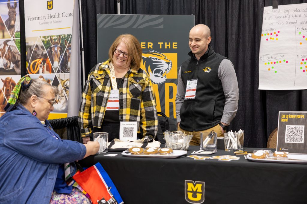 people talk at a booth