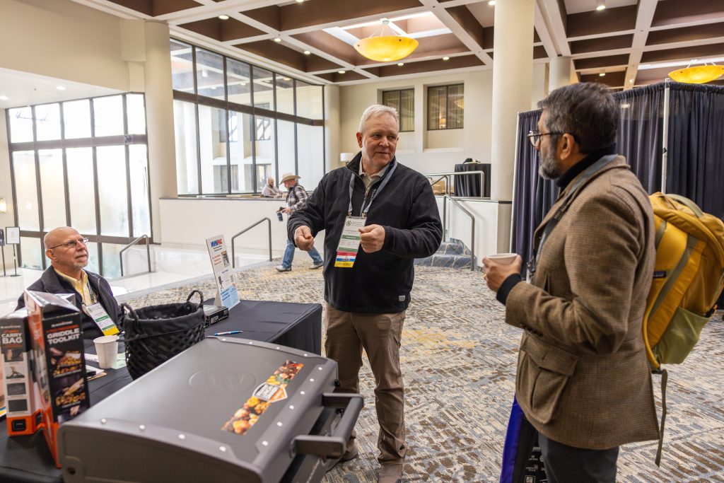 Dean Sri speaks with attendees