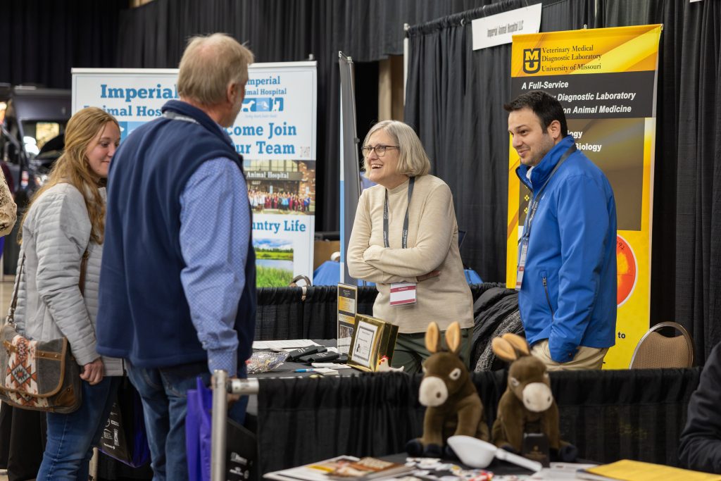 people talk at a booth
