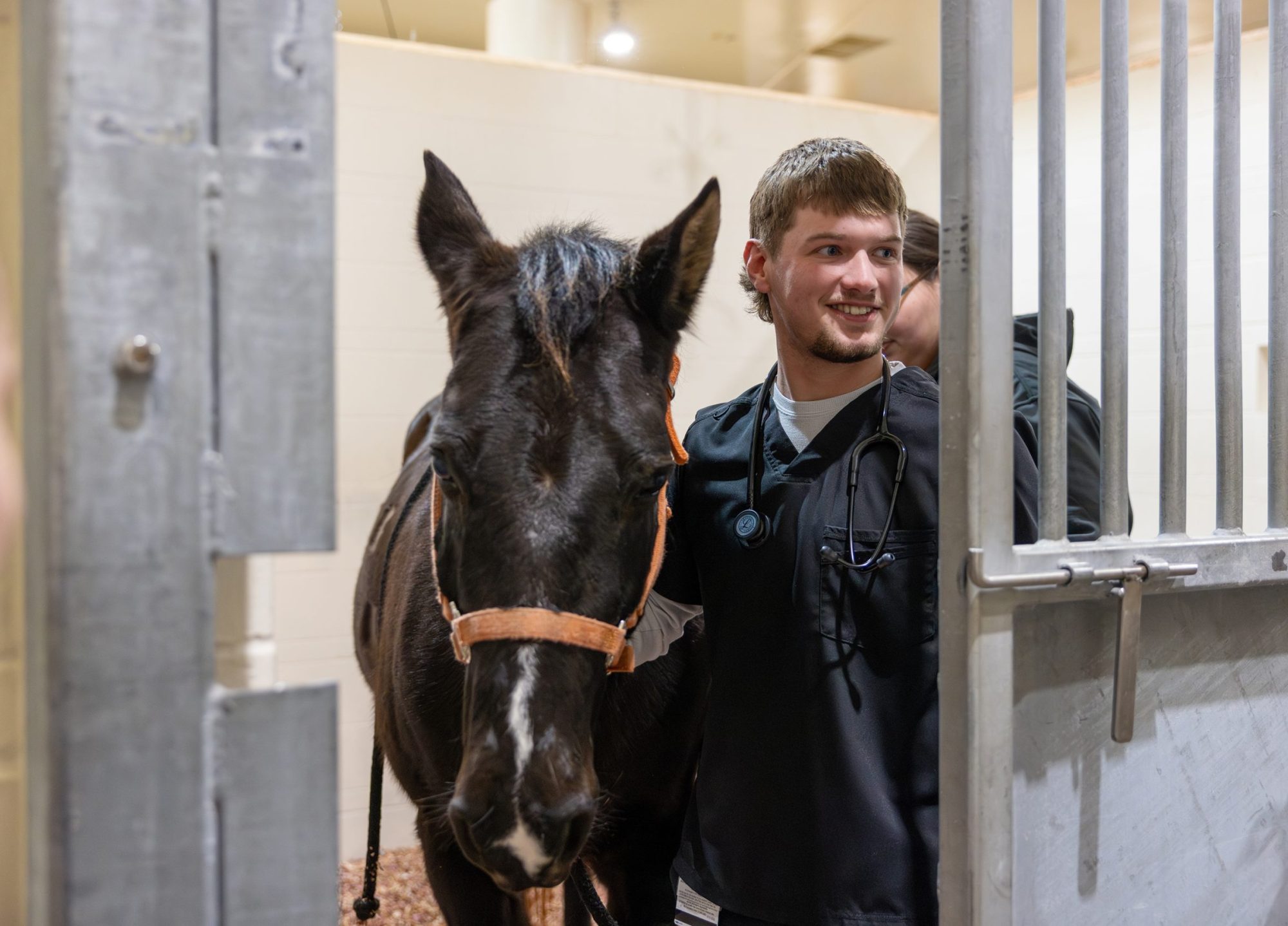 A student walking with a horse
