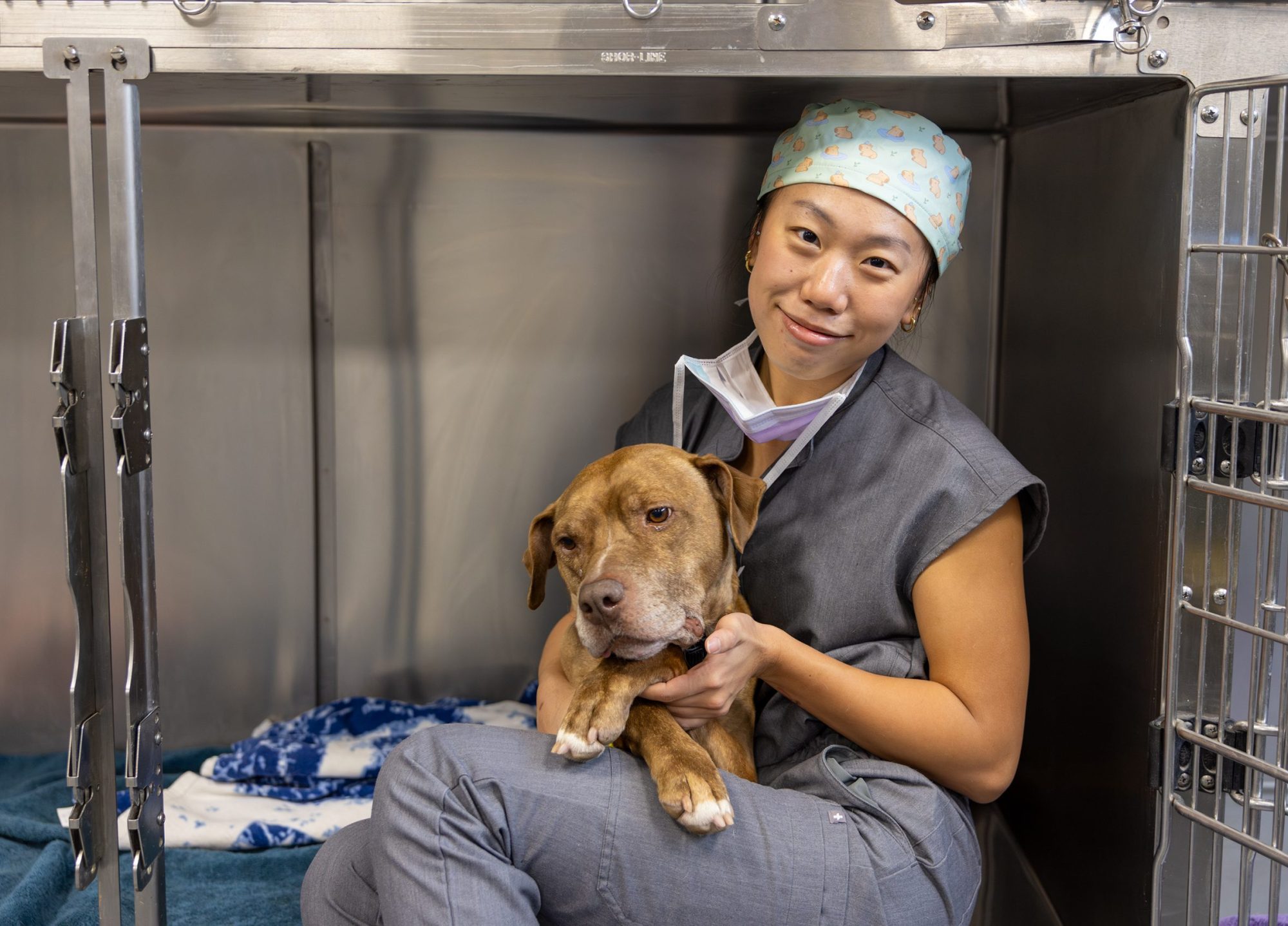 A student holding a dog