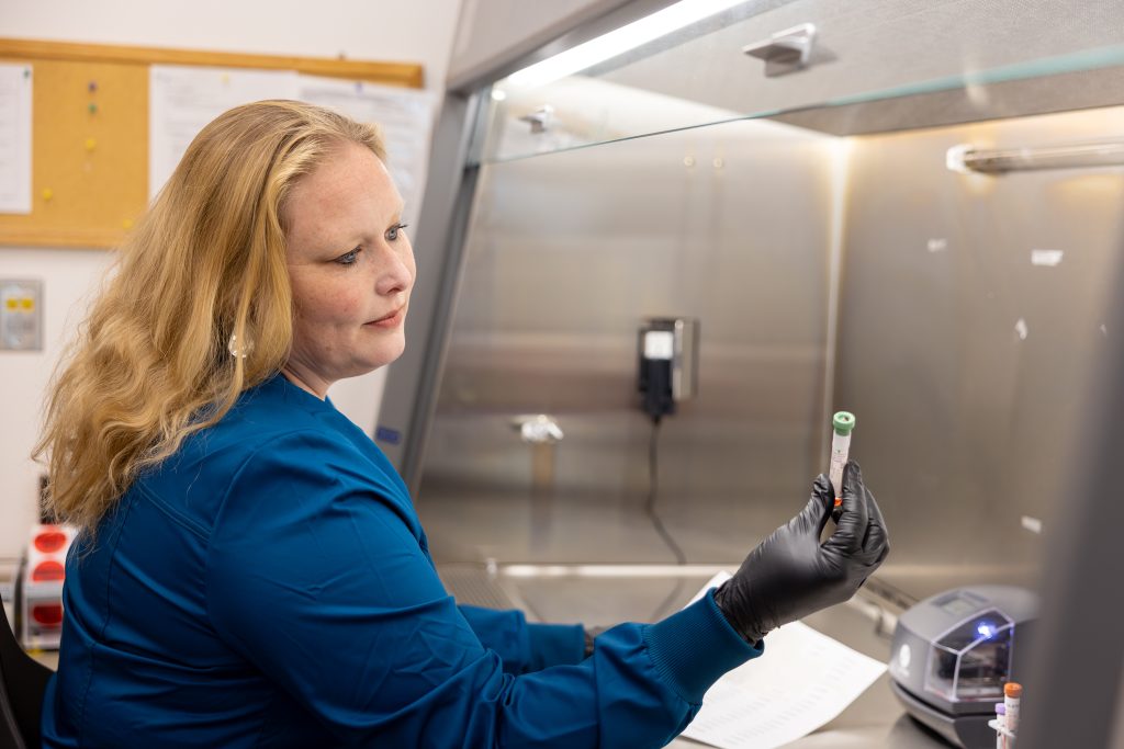Lauren Delaney looking at a testing sample