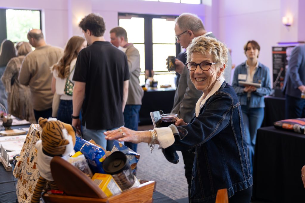 an event-goer peruses silent auction items