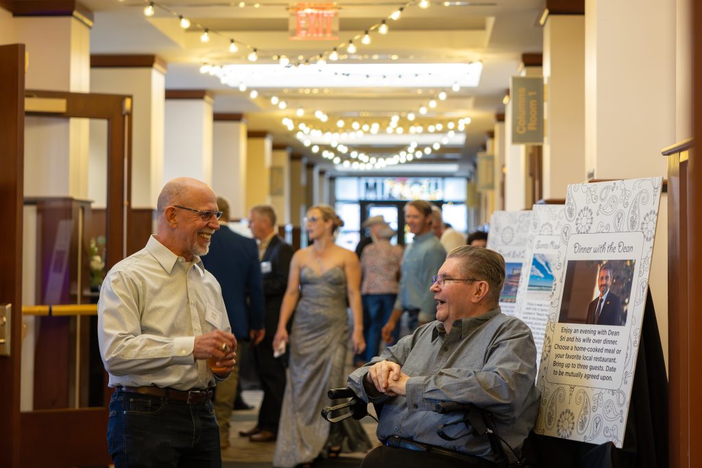 event-goers smile and chat