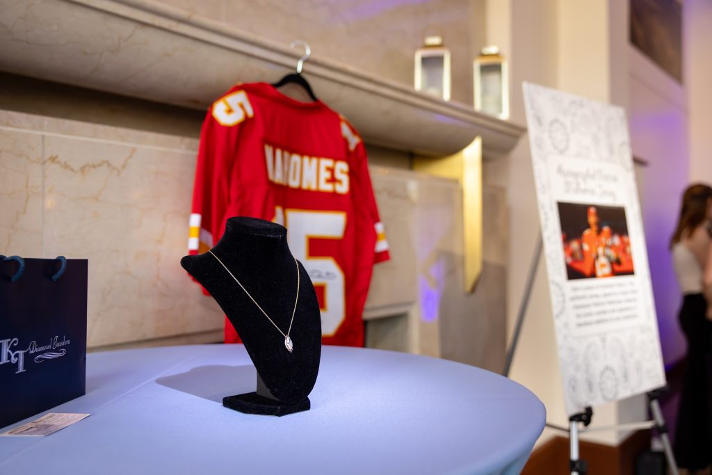 a signed mahomes jersey and a diamond necklace