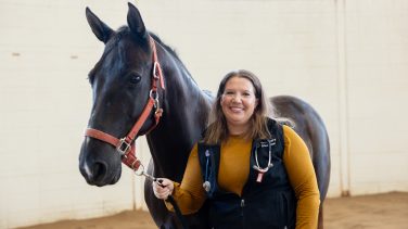 Hannah Leventhal photographed next to a horse.
