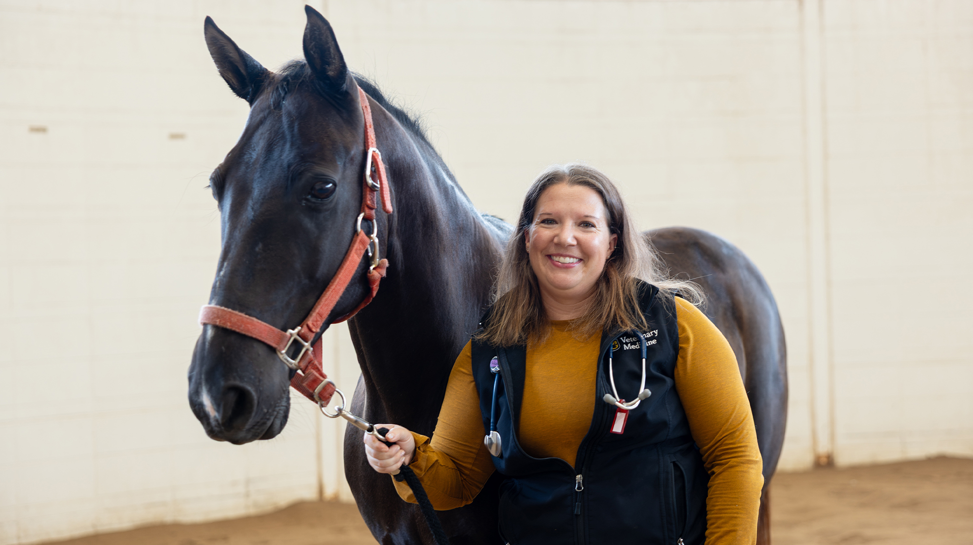 Hannah Leventhal photographed next to a horse.