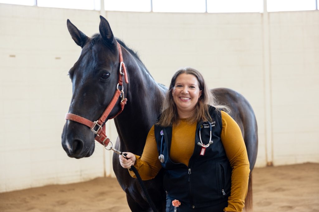Hannah Leventhal photographed next to a horse.