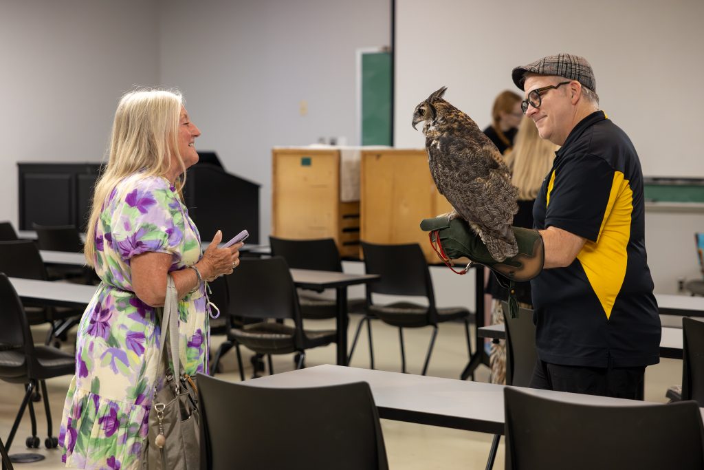 a woman, a man and an owl