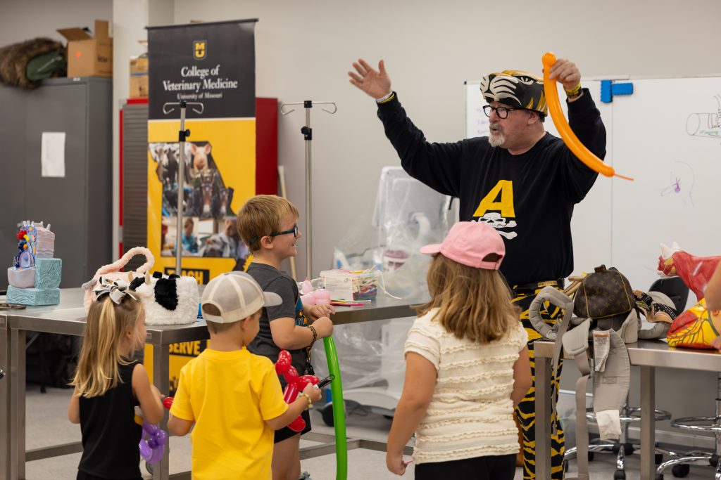 Dr. Evans making balloon animals for children