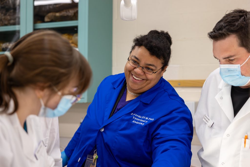 Rowena Woode smiling at a student.